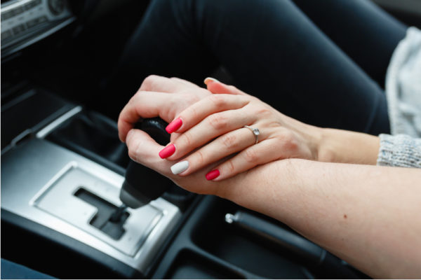 Couple Holding Hands in Nice Car